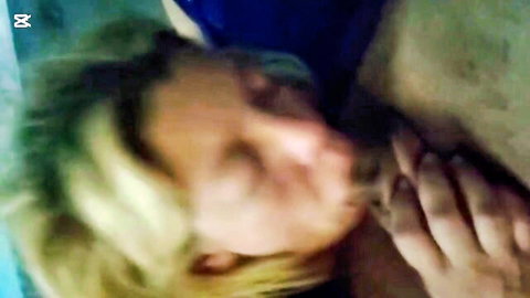 Blonde woman nuzzling and kissing man's bare chest passionately in amateur couple embrace