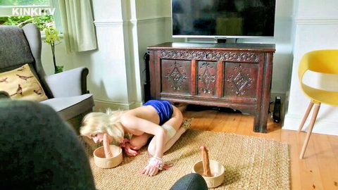Blonde April kneels licking bowls in pet training fetish