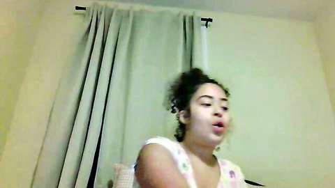 Ellibell26 curly-haired mixed beauty in white tank top, open-mouthed cam tease