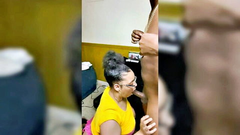 Ebony woman in yellow sundress giving blowjob to black stud