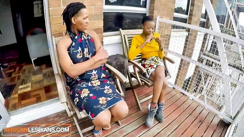 Two black amateur lesbians in casual dresses on balcony secret meetup