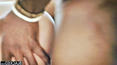 Black man's hand squeezing pale white woman's big tit with erect nipple