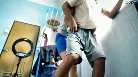 Amateur Asian gay couple in intimate bedroom embrace