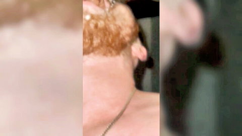 Close-up of cute red-bearded guy in intense oral action