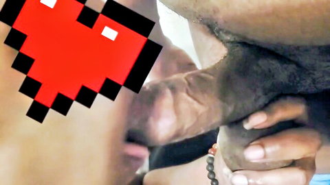 Close-up of light-skinned woman sucking big black cock intensely