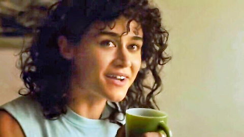 Kristen Stewart smiling with mug in casual tank top, Love Lies Bleeding scene