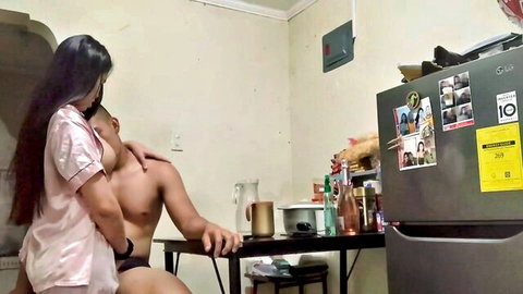 Asian couple in intimate embrace, woman in pink lingerie hugs shirtless man