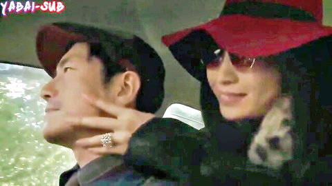 Asian couple intimate moment in car, woman in red hat and sunglasses