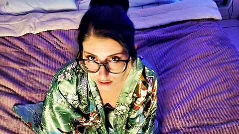 POV seductive brunette MILF in glasses opens floral kimono robe revealing deep cleavage and tits on bed