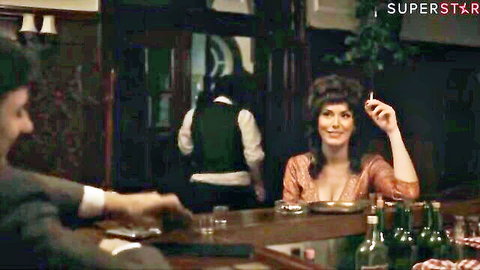 Busty brunette with medium tits cleavage smokes cigarette at vintage bar with suited men