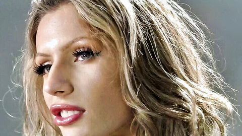 Closeup of sexy blonde with glossy plump lips and heavy eyelash makeup teasing seductively