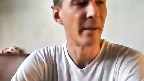 Close-up of mature man in white t-shirt smiling at camera