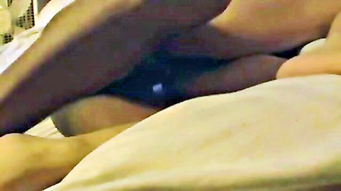 Black bull's muscular thigh in blue underwear pressed against white wife's pale leg on bed