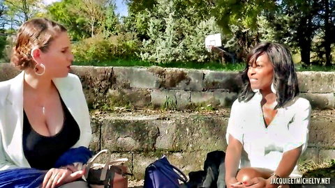 Passionate ebony and blonde in sexy blazers chatting outdoors
