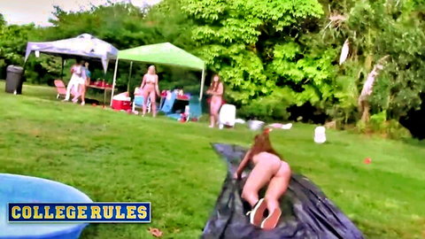 Nude college girls slipping on wet slide outdoors at wild party
