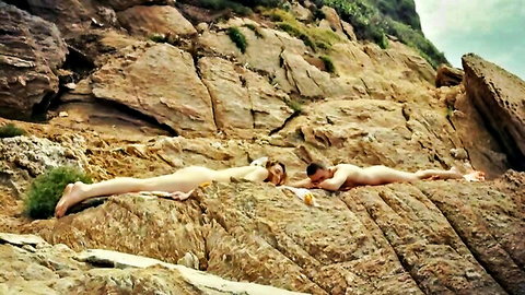Juliette Savary nude sunbathing topless on rocks with friend in Carpobrotus 2024