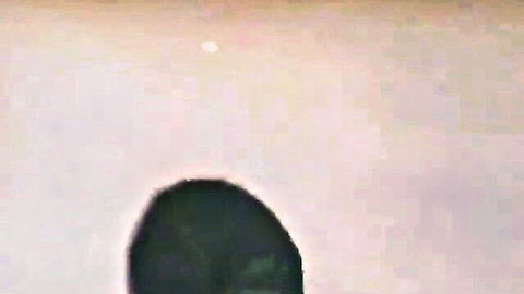 Blurry Japanese glory hole scene with women handjobbing man through box
