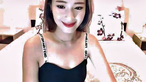 Cute Asian brunette webcam amateur smiling with medium tits cleavage in black Guess top