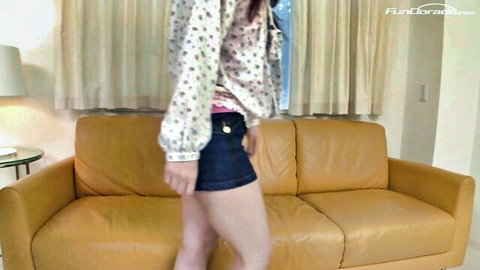 Steamy Chinese nubile in floral blouse and tight denim shorts posing teasingly