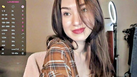 Eminemswife Chaturbate webcam tease, brunette smiling in plaid shirt