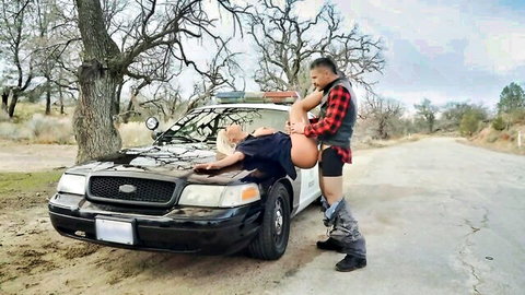 Muscular flannel guy fucks policewoman missionary on cop car hood outdoors