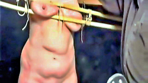 Pale big-titted submissive bound tightly with yellow ropes exposing her bare breasts in BDSM domination