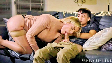 Curvy blonde MILF kissing young guy passionately while groping his crotch on couch with ass up