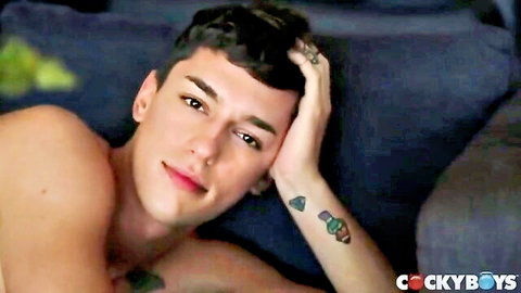 Blake Mitchell shirtless and tattooed, seductive pose on CockyBoys