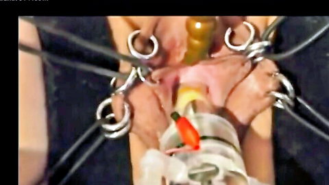 Bound vagina close-up with speculum insertion in shocking BDSM fetish scene