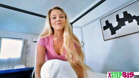 Blonde teen stepsister teasing in low-cut pink top on bed