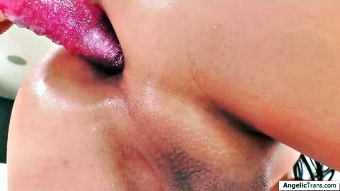 Chanel Santini licks pink glittery anal toy with tongue close-up