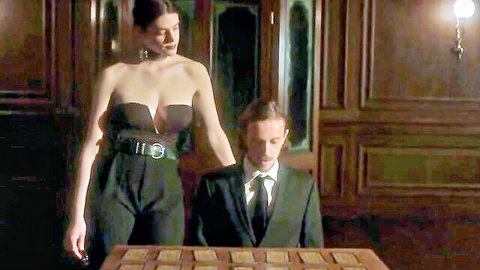 Brunette with deep cleavage in low-cut top grips suited man's head at tarot table