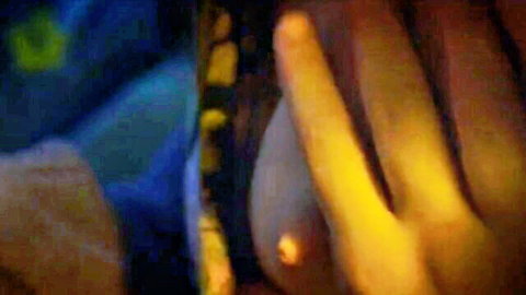 Man's hand squeezing young woman's small nude tit and erect nipple closeup
