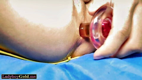 Ladyboy close-up of anal toy insertion with visible penetration