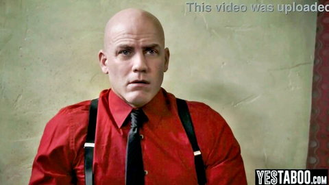 Bald muscular man in red shirt and suspenders stares intensely in college threesome preview