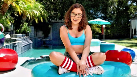 Brunette teen with glasses and big tits teases in blue bra shorts red knee socks poolside