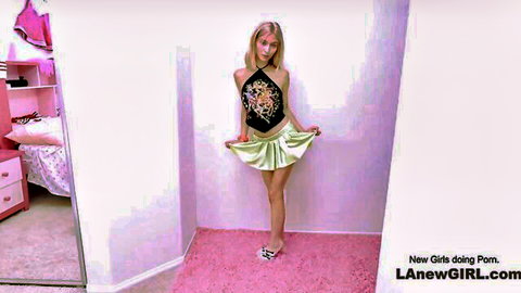 Super cute petite blonde girl in tiny body posing in halter top and mini skirt