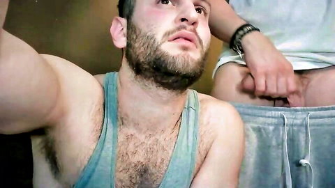 Bearded hairy hunk in tank top gets sweatpants yanked down exposing bare ass by groping buddy