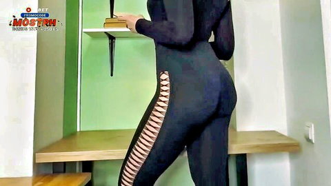 Sexy Asian teacher in tight black bodysuit and heels, posing to show curves