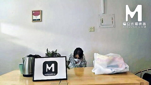 Asian woman in light clothing at table with white cover, Invisible Sex setup from Model Media