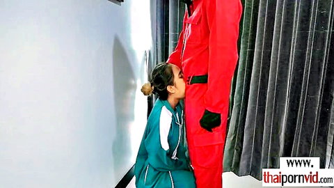 Skinny Thai teen Cherry kneels before big cocked guard in red suit, amateur penalty scene