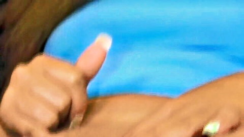Horny lesbian MILFs giving thumbs up in blue top, intimate hand pose