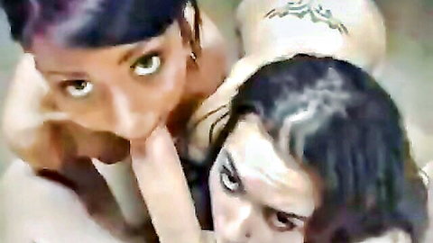 Two sexy teens with purple and dark hair sharing intimate oral play, nude and close-up