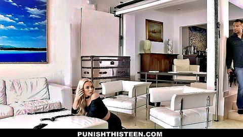 Blonde teen in tight black top and skirt seduces man in luxury room