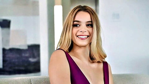 Molly Little smiling seductively in low-cut purple dress
