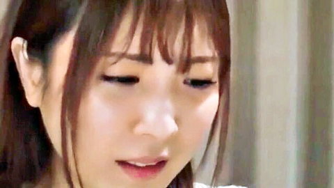 Closeup of sexy Japanese woman with bangs, squinted eyes and parted glossy lips ready for cock