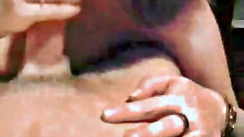 Closeup of woman's hand with wedding ring gripping and stroking thick erect cock