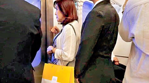 Busty Japanese housewife crowded by suited men groping her ass on subway train