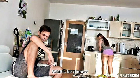 Bored husband sits watching hot wife bend over kitchen counter in tiny pink shorts showing juicy ass