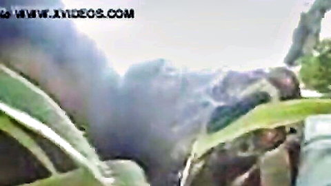 Blurry Indonesian outdoor encounter with foliage and figure in revealing pose
